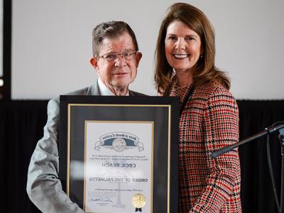 Dr. Cecil Beach displays The Order of the Palmetto with South Carolina Lt. Gov . Pamela Evette (SC Lt. Gov. Facebook) 